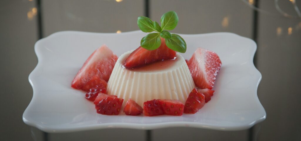 Panna Cotta dessert covered in strawberries. 